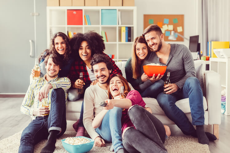 Group of yound adults enjoying watching T V together