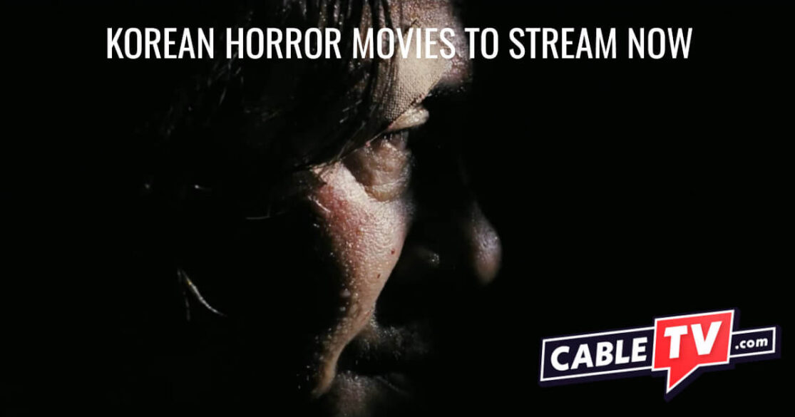 A Korean man hides in a dark room. We see only his partially lit face.