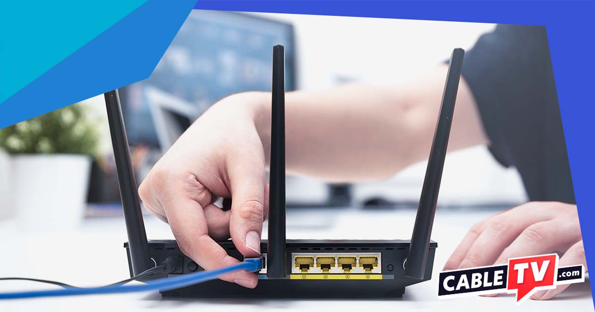 Person plugging cord into a router