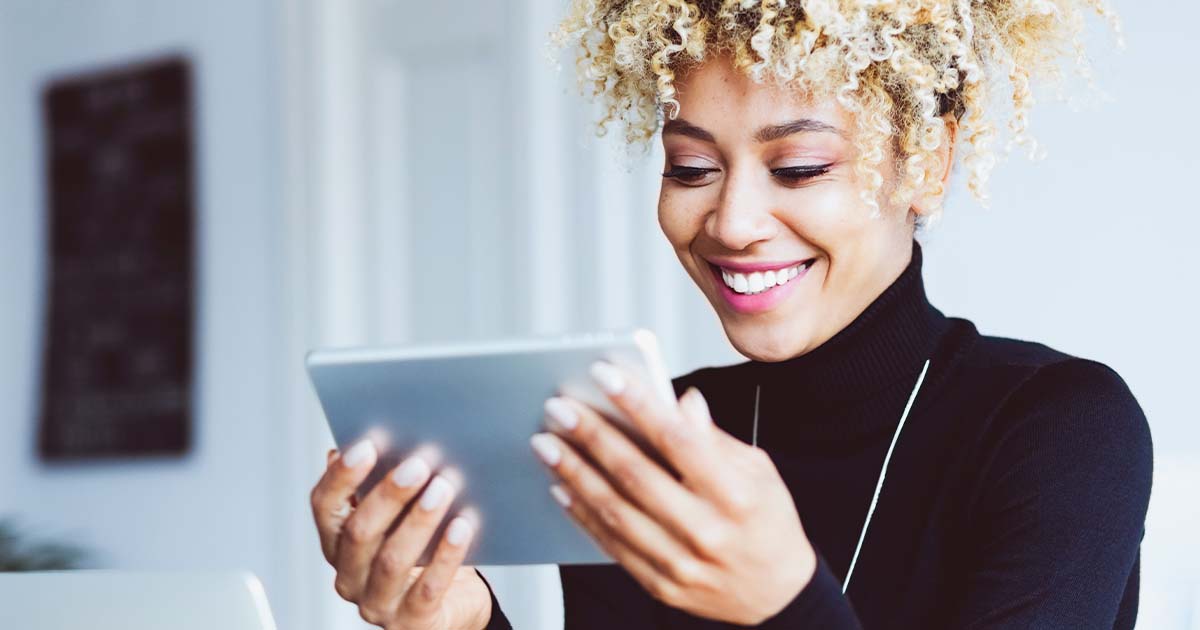 woman looking at tablet using internet