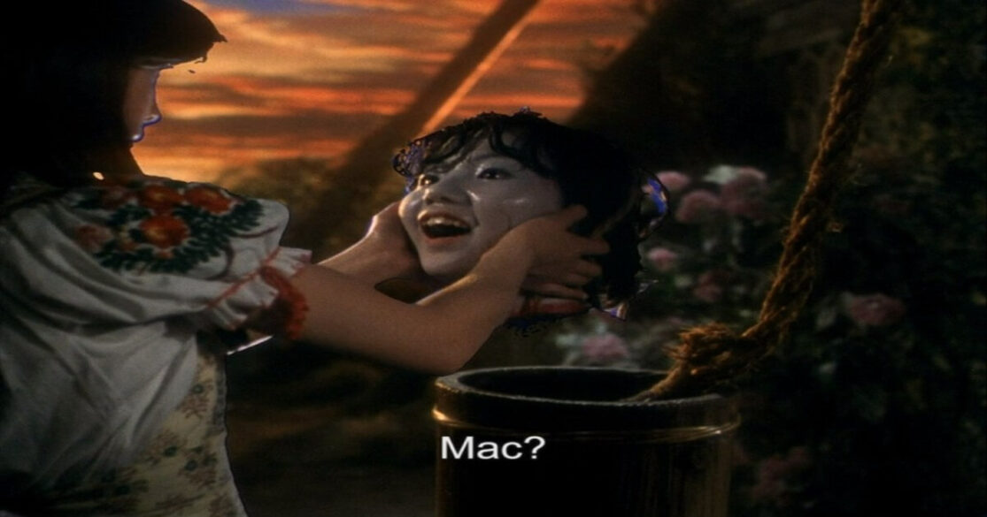 A young girl holds the still-living and talking head of her friend.