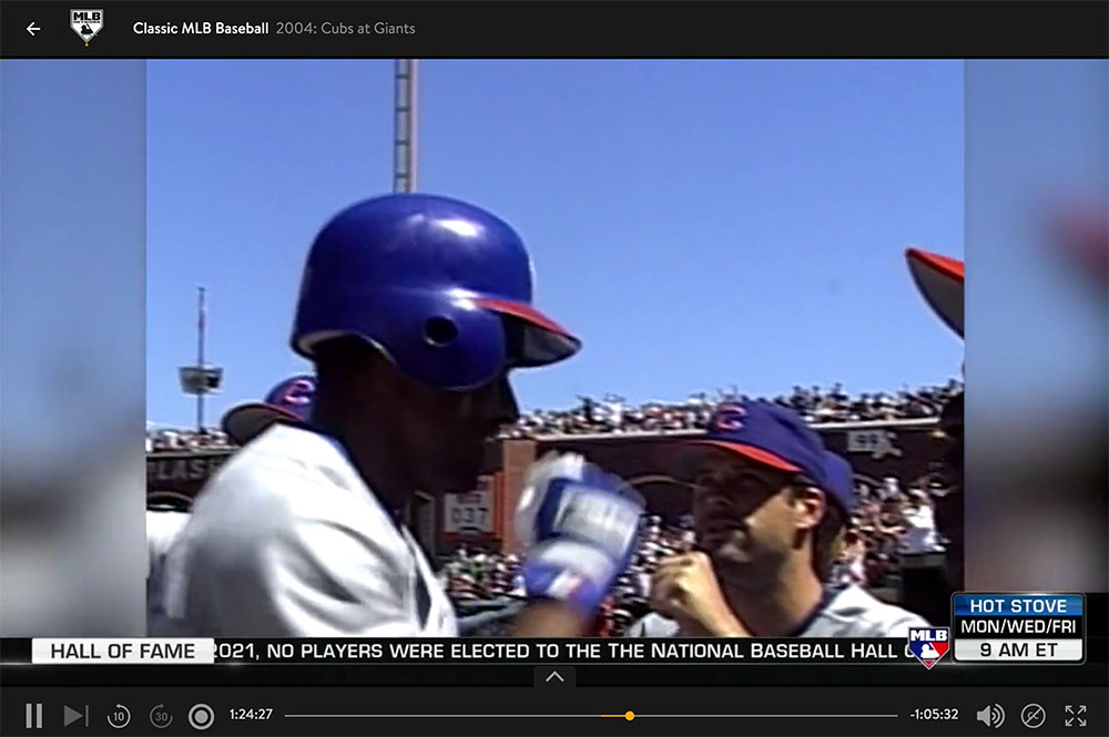Corey Patterson of the Chicago Cubs fist bumps teammates while heading back to the dugout during MLB Network’s airing of Classic MLB Baseball on Sling TV.
