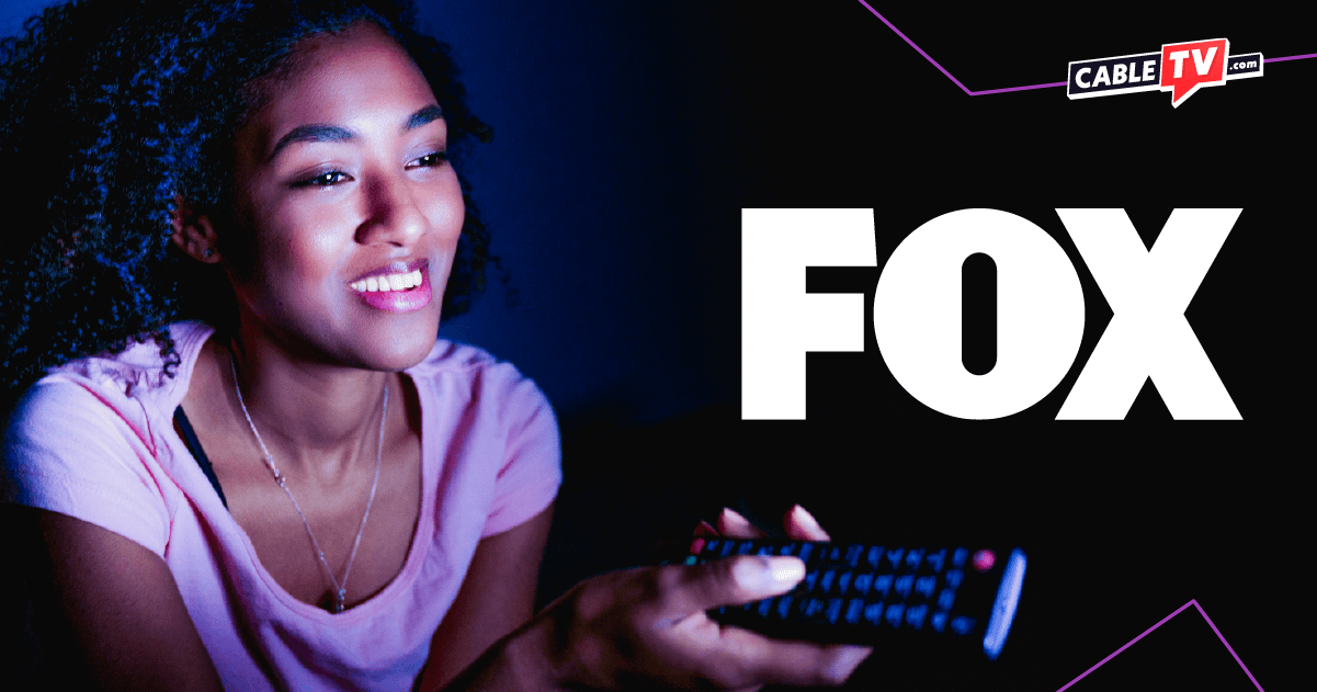 A woman holding a remote with the FOX and CableTV.com logos on the righthand side.