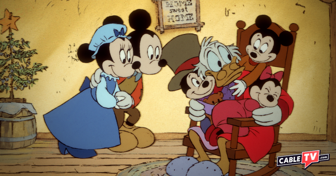 In a scene from Mickey's Christmas Carol, Mickey and Minnie (as the Cratchits) look on as their children sit on Scrooge McDuck's lap, cuddling. Mickey's Christmas Carol is one of our 10 best Christmas movies for kids.