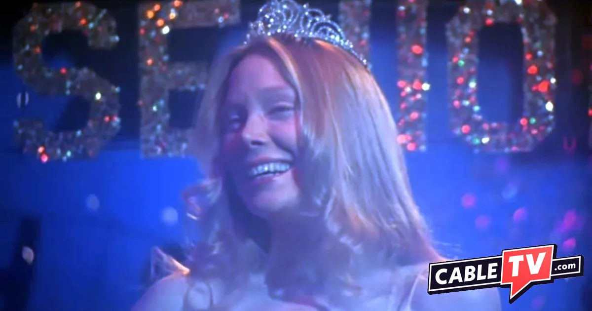 The prom scene from Carrie shows a smiling young woman wearing a tiara.
