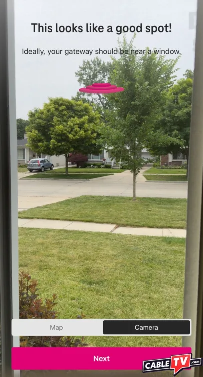 A screenshot of the gateway placement tool in T-Mobile’s mobile app. A street is displayed onscreen with a Wi-Fi antenna graphic and the text “This looks like a good spot.”