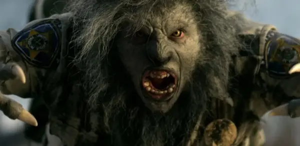 A werewolf in a police uniform lunges toward the camera, filling the frame. A scene from Wolfcop, one of several free horror movies to stream right now.